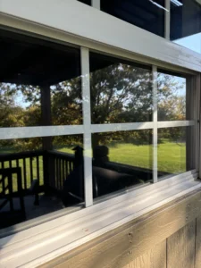 reflection of trees and sunlight in a clean residential window near kansas city