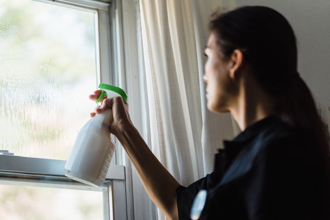 Close-up of professional squeegee cleaning technique for streak-free home windows